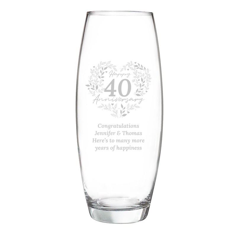 May include: A clear glass bullet-shaped vase featuring an etched design of a leafy heart surrounding the text Happy 40 Anniversary. Below the heart, the text reads Congratulations Jennifer & Thomas Here's to many more years of happiness.