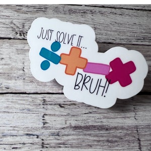 May include: White sticker with a cloud shape and the text "JUST SOLVE IT... BRUH!" with colourful maths symbols.