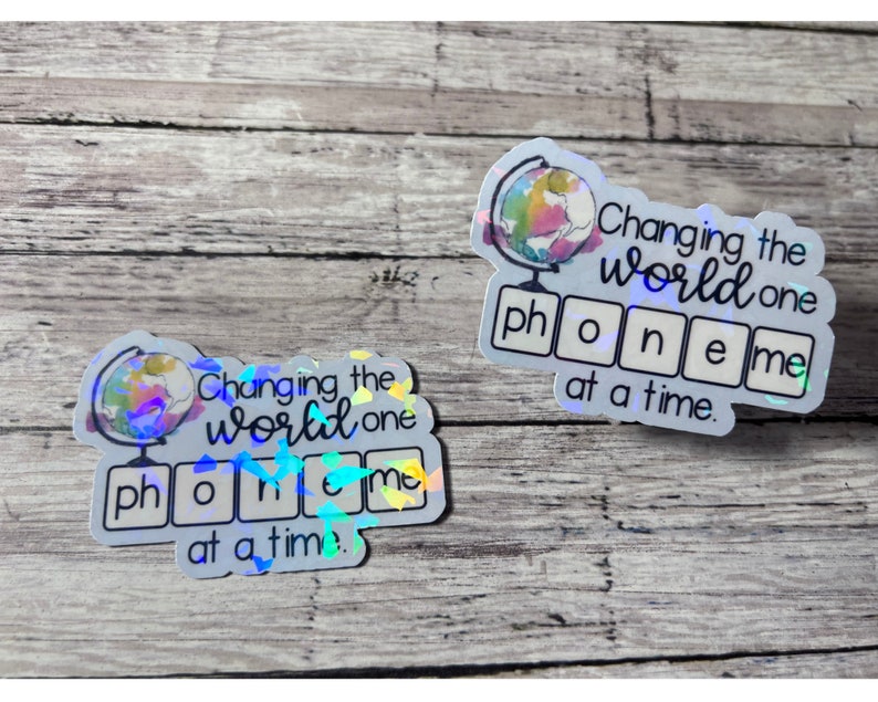 May include: Two iridescent stickers with a globe illustration and the text "Changing the world one phoneme at a time."