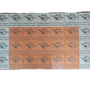 May include: A collection of 28 small, rectangular, brown and white paper tickets with the text "The History Museum South Bend, Indiana" repeated on each ticket.