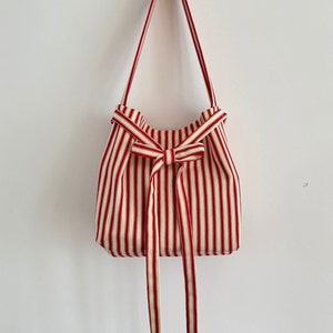 Stripped red and cream bag handbag with bow fastening