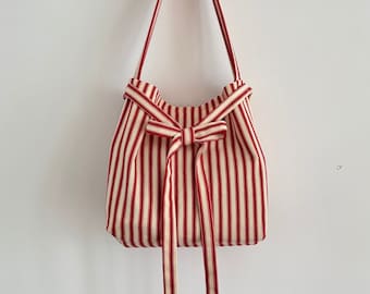 Stripped red and cream bag handbag with bow fastening