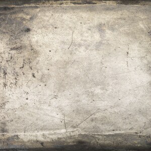 May include: A close-up of a textured, gray surface with a worn, aged appearance. The surface has a subtle sheen and shows signs of scratches and marks.
