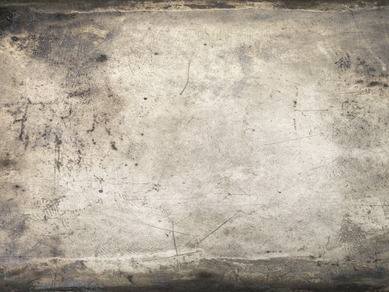 May include: A close-up of a textured, gray surface with a worn, aged appearance. The surface has a subtle sheen and shows signs of scratches and marks.