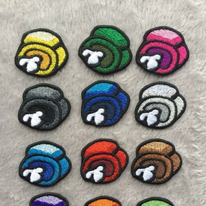 May include: Twelve embroidered iron-on patches featuring different colored characters from the popular video game Among Us. The characters are all in the same pose, with their arms raised and their mouths open.