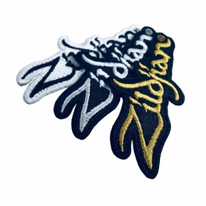 May include: Three embroidered patches featuring the word "Ziggy" in different styles. The top patch is white with black stitching, the middle patch is black with white stitching, and the bottom patch is black with gold stitching.