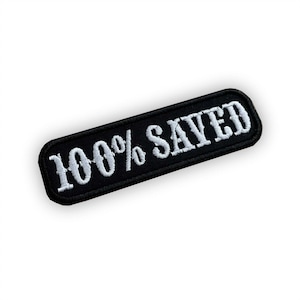 Peut inclure: Écusson brodé noir avec du texte blanc qui dit "100% SAUVÉ".