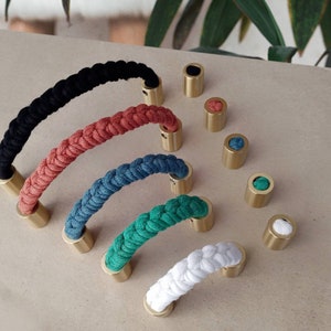 May include: Five different colored rope cabinet pulls with brass end caps. The pulls are black, coral, teal, green, and white.