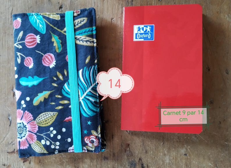 May include: A floral patterned notebook cover with a teal elastic band next to a red notebook. The red notebook has the Oxford logo and the text "Carnet 9 par 14 cm". The notebook is approximately 3.5 x 5.5 inches.
