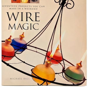 May include: A book titled "Wire Magic: Seventeen Projects You Can Make in a Weekend" by Michael Ball. The cover features a wire chandelier with colorful glass globes.