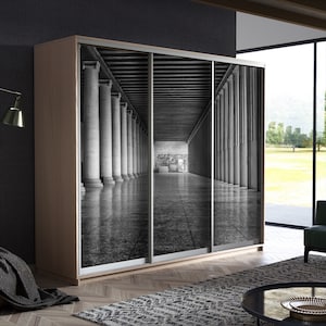 May include: A black and white photograph of a long hallway with columns on either side. The hallway is empty and the floor is tiled. The photograph is printed on a sliding closet door.