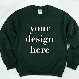 May include: A dark green sweatshirt with the text "your design here" printed in white on the front.