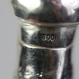 May include: Close-up of a silver object with the number "800" stamped on it.