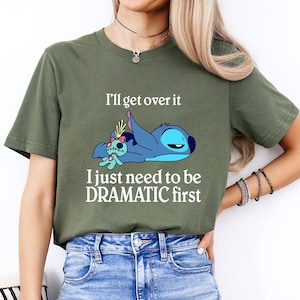 May include: A green t-shirt with a blue cartoon character and the text "I'll get over it I just need to be DRAMATIC first"