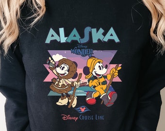 May include: Black sweatshirt with a graphic of Mickey and Minnie Mouse in winter gear, with the text "Alaska Disney Wonder Disney Cruise Line".