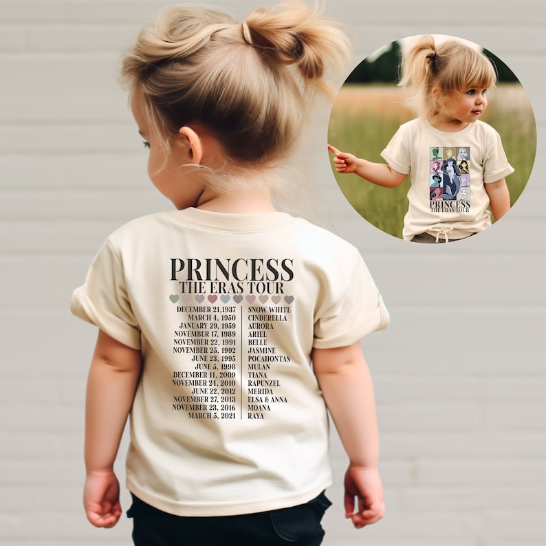 Puede incluir: Una camiseta beige claro con un estampado gr&aacute;fico de las princesas Disney y sus fechas de lanzamiento. El texto "PRINCESS THE ERAS TOUR" est&aacute; impreso en la camiseta.