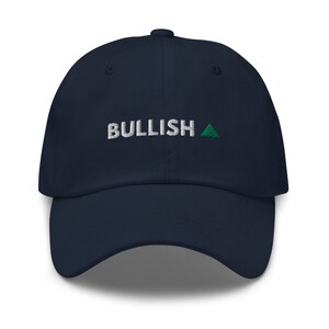 May include: A navy blue baseball cap with white embroidered text that reads "BULLISH" and a green triangle.