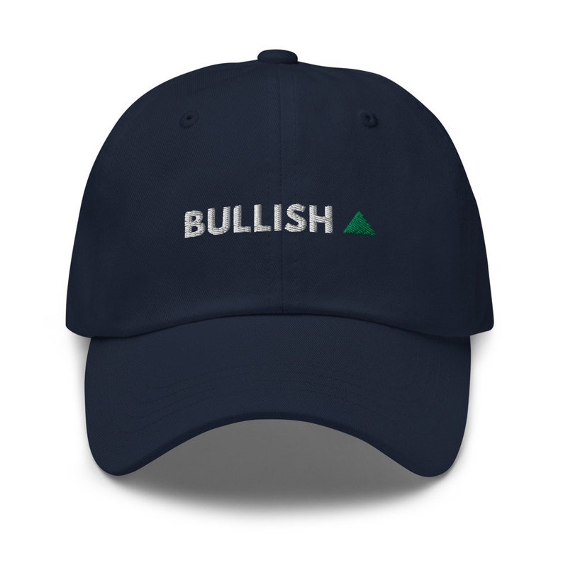 May include: A navy blue baseball cap with white embroidered text that reads "BULLISH" and a green triangle.