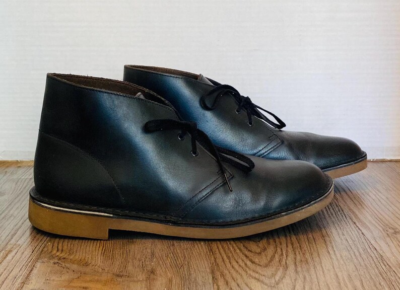 May include: A set of three ceramic mugs with a speckled, matte finish. The mugs are in shades of cream, light gray, and dark gray. Each mug has a simple, minimalist design and a rounded handle.