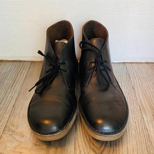 May include: A set of three ceramic nesting bowls in shades of blue, green, and white. The bowls feature a speckled glaze and a simple, modern design. The largest bowl measures approximately 8 inches in diameter.