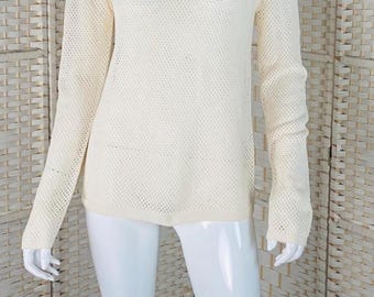 May include: Off-white, long-sleeved sweater with a crew neck and a mesh-like knit design. The sweater is displayed on a white mannequin against a neutral background. The knit pattern creates a textured appearance.