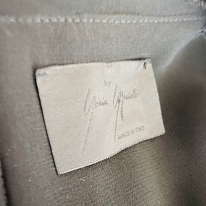 May include: A white tag with the text "by Maria Grachilde" and "Made in Italy" in black lettering.