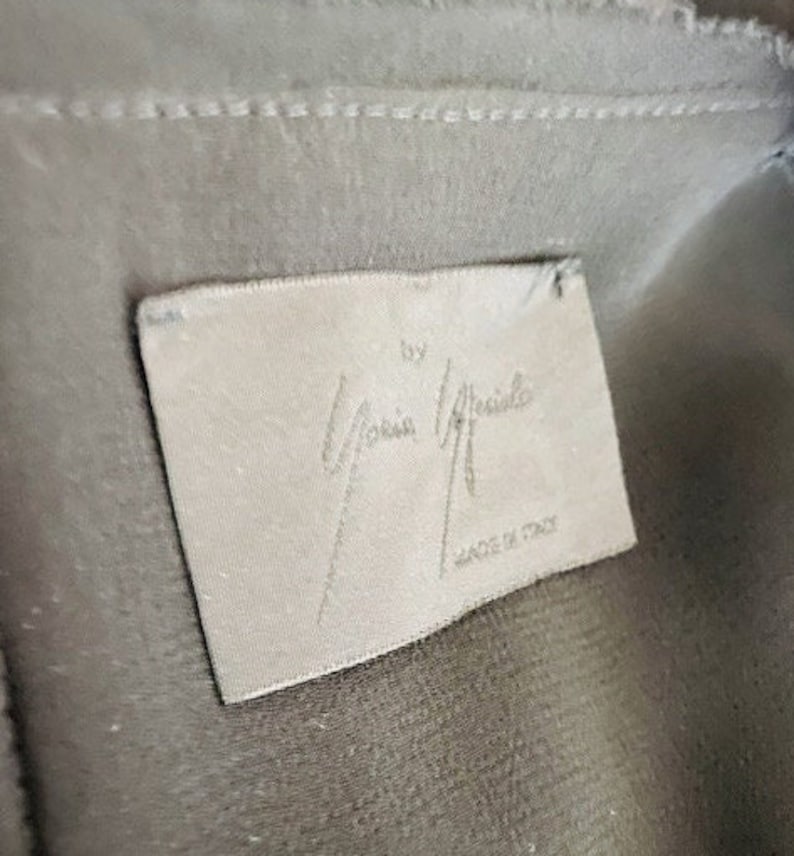 May include: A white tag with the text "by Maria Grachilde" and "Made in Italy" in black lettering.