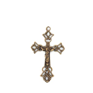 May include: Ornate bronze-colored crucifix with a detailed depiction of Jesus Christ. The cross features decorative openwork and a loop at the top for hanging. The religious item is set against a white background.