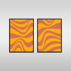 May include: Two framed prints with abstract wavy patterns in orange and pink. The prints are side-by-side and have black frames.