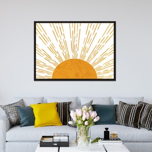 Puede incluir: Una impresi&oacute;n enmarcada de un sol estilizado con rayos naranjas sobre un fondo blanco. El sol es de color naranja s&oacute;lido.