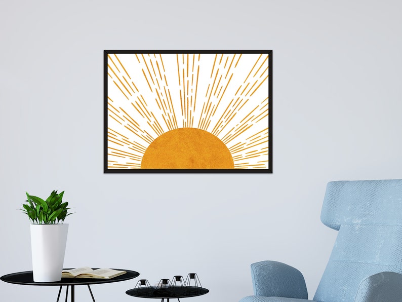 Puede incluir: Una impresi&oacute;n enmarcada de un sol estilizado con rayos amarillos y naranjas que irradian hacia afuera desde un c&iacute;rculo amarillo dorado.