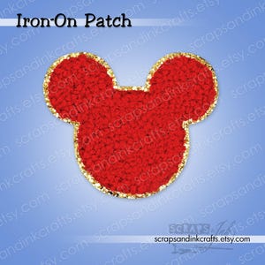 May include: Red Mickey Mouse-shaped iron-on patch with a gold glitter border. The patch has a textured, plush appearance and the words "Iron-On Patch" are at the top.