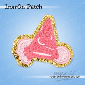 May include: Pink and white cheerleader megaphone iron-on patch with gold glitter border. The patch has the text "Iron-On Patch" at the top. The Etsy shop URL is visible at the bottom.