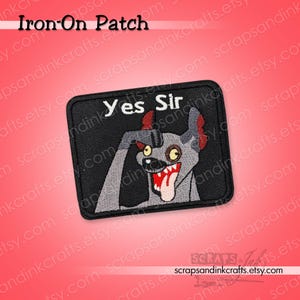 May include: A rectangular iron-on patch with a black background featuring an embroidered gray hyena character with red ears, a wide open mouth with white teeth, and a protruding tongue. The text Yes Sir is embroidered in white above the character.