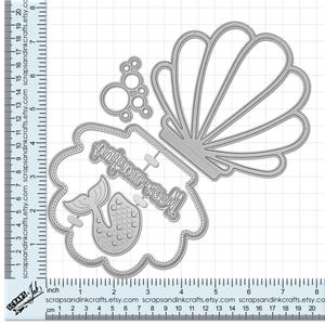 May include: Metal die cuts for crafting, featuring a mermaid, a seashell, and the words "Mermaid Ice Cream".