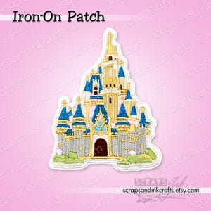 May include: An embroidered iron-on patch featuring a detailed castle design with gold, blue, and pink accents. The patch has a white border and includes the text "Iron-On Patch". The patch is on a pink background.
