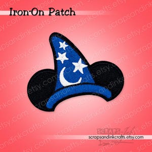 May include: An embroidered iron-on patch shaped like a wizard hat with a blue pointed top featuring white stars and a crescent moon, contrasted by a black brim. The text Iron-On Patch is visible at the top and the shop name at the bottom.