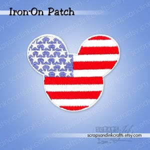 May include: An iron-on patch in the shape of a mouse head, featuring the American flag design. The patch has a white border, with the left ear displaying blue stars and the right ear and head showing red and white stripes. The text "Iron-On Patch" is at the top.