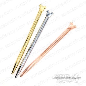 May include: Three metal pens with a Mickey Mouse head design on the top. The pens are gold, silver, and rose gold. The pens have a ribbed design on the barrel and a black ink tip. The pens are on a white background.