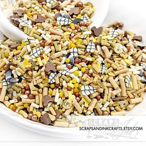 May include: A variety of colorful sprinkles in a white bowl. The sprinkles are in the shape of stars, hearts, and other shapes. The sprinkles are a mix of brown, white, yellow, and black.