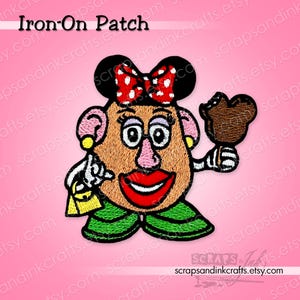 May include: Embroidered iron-on patch featuring a cartoon character with a tan face, red lips, and a red bow with white polka dots. The character is holding a brown ice cream and a yellow purse. The text "Iron-On Patch" is at the top.