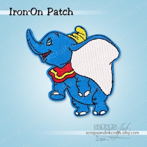 May include: Blue iron-on patch featuring a cartoon elephant with large ears. The elephant has a red collar with yellow trim and a yellow hat. The patch has the text "Iron-On Patch" at the top.