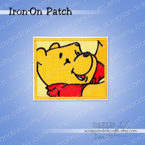 May include: Yellow embroidered iron-on patch featuring a cartoon bear in a relaxed pose. The bear is wearing a red shirt and is set against a yellow background. The patch has a yellow border and the text "Iron-On Patch".