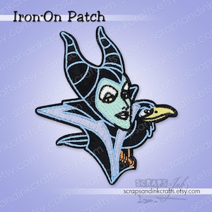 May include: Embroidered iron-on patch featuring a stylized depiction of a character with black horns, a green face, and a black raven. The patch has a light blue outline and the text "Iron-On Patch".
