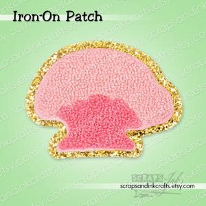 May include: Pink mushroom-shaped iron-on patch with a gold glitter border. The patch has a textured appearance and the text "Iron-On Patch" is visible at the top. The Etsy shop name "scrapsandinkcrafts.etsy.com" is at the bottom.
