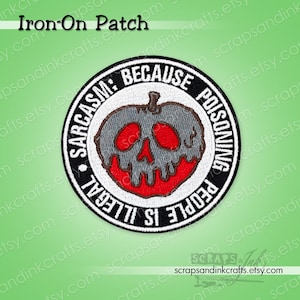 May include: Round iron-on patch with a black border and white text that reads "Sarcasm: Because poisoning people is illegal." The patch features a gray apple with a red skull design.