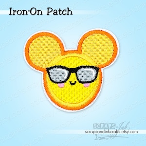 May include: Yellow iron-on patch in the shape of a smiling sun wearing black sunglasses. The patch has orange trim and two rounded ears. The text "Iron-On Patch" is at the top.