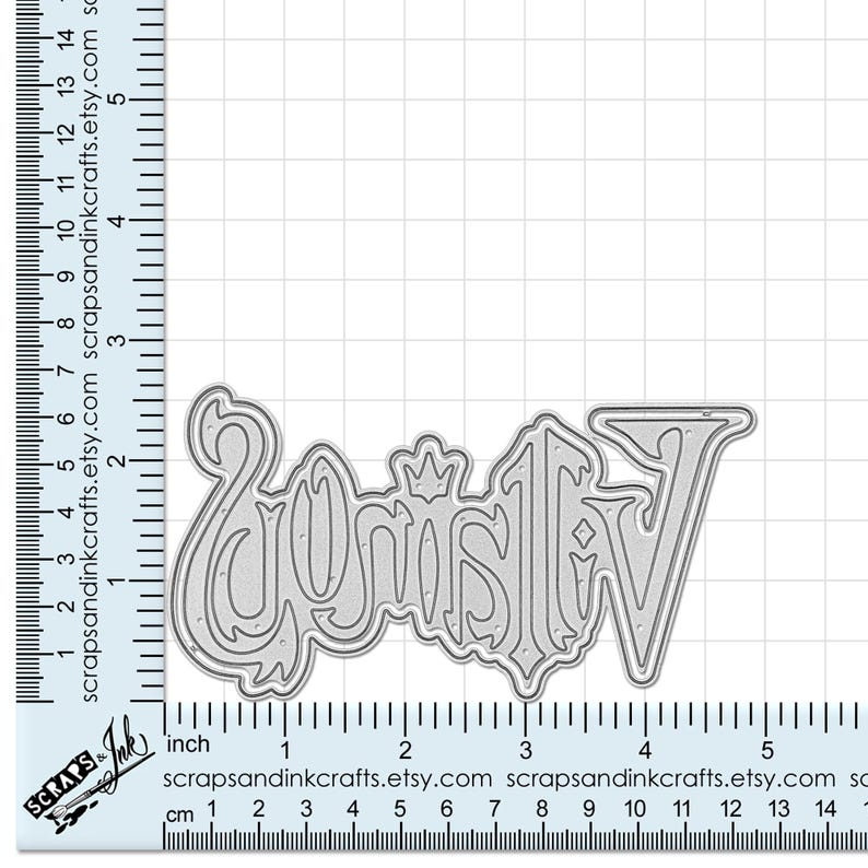 May include: A silver metal die cut of the word "Joy" with a crown on the "J". The die cut is approximately 3 inches wide.