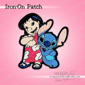 May include: Embroidered iron-on patch featuring Lilo and Stitch characters. Lilo is in a red dress with white floral patterns, and Stitch is blue. The patch has a black border and the text "Iron-On Patch" at the top.