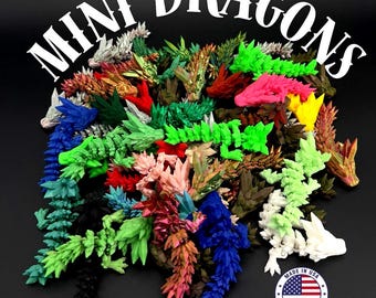 May include: A collection of colorful, miniature dragon figurines in various shades of green, blue, red, pink, and yellow. The text "MINI DRAGONS" is arched across the top. A "Made in USA" sticker is in the bottom right corner. The dragons are on a black background.